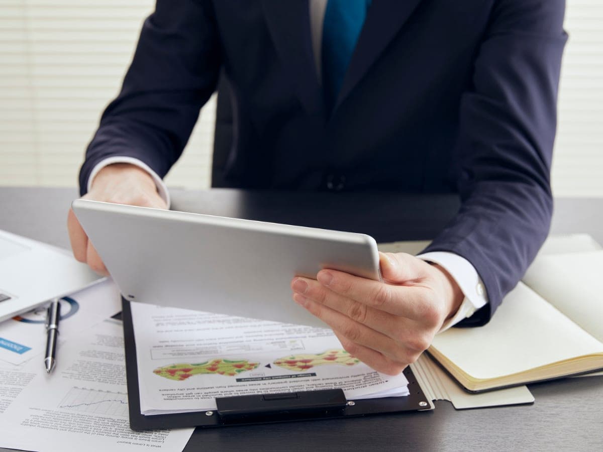 A professional reviewing career documents and market data